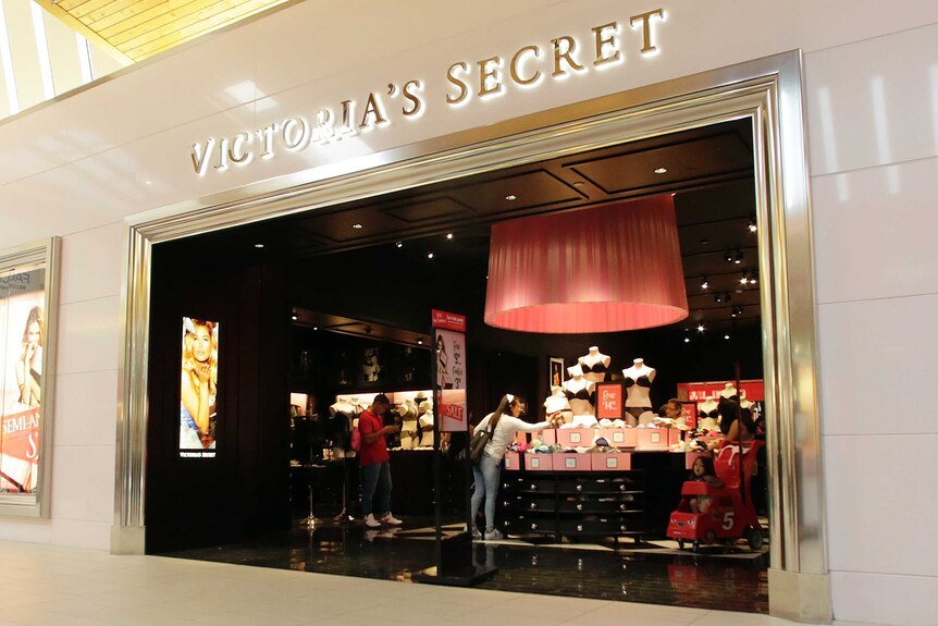 A shot from outside a Victoria's Secret store, which shows shoppers browsing the merchandise.