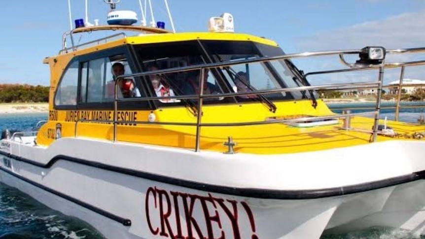 A yellow boat called 'crikey' is moored