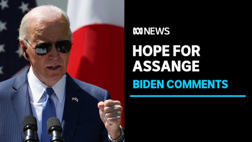 Hope for Assange, Biden Comments: US President Joe Biden, wearing aviator sunglasses, speaks with microphones in front of him.