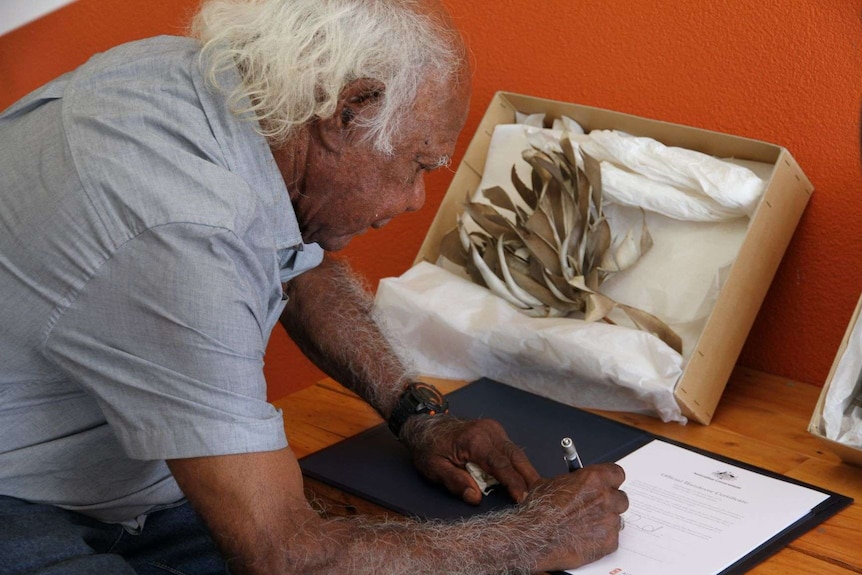 A man signing a document.