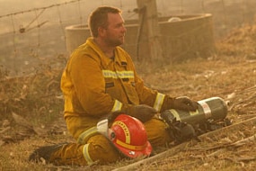 A Country Fire Authority volunteer takes a break on Black Saturday. (AFP: William West)