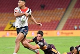 Two Broncos players collapse to the floor after failing to tackle Daniel Tupou