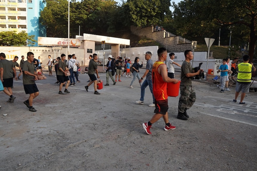 soldeirs carrying debris in Hong Kong's streets.