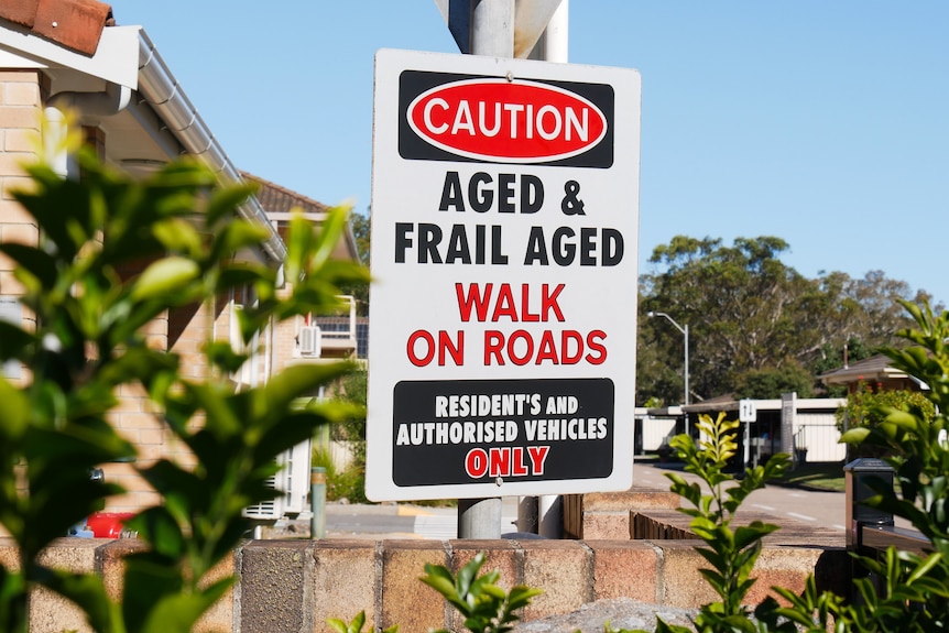 A sign that reads 'Caution, Aged and Frail Aged walk on roads. Residents and authorised vehicles only'