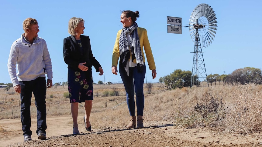 Fiona Nash walks along a dirt track with 2017 Trailblazers Jake Lloyd and Elizabeth Tate.