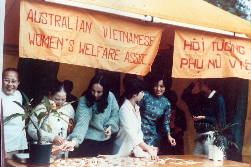 Vietnamese women work at a fundraising stall