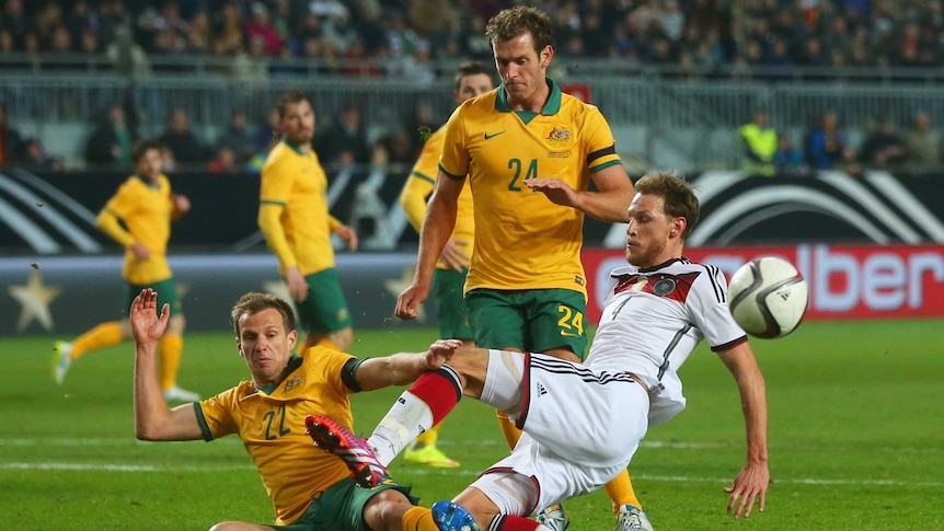 Brave performance ... Germany's Benedikt Hoewedes is challenged by Alex Wilkinson and Luke DeVere