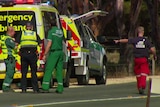 Police and paramedics attend a fatal crash.