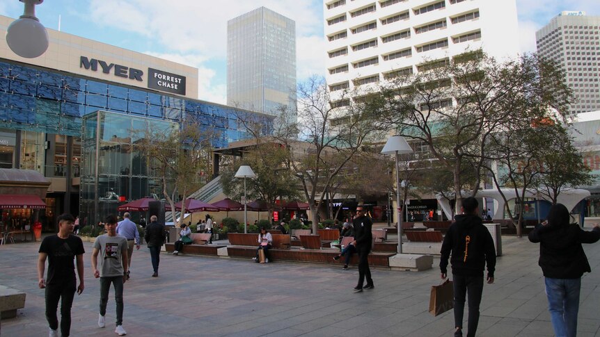 People passing through a plaza in central Perth