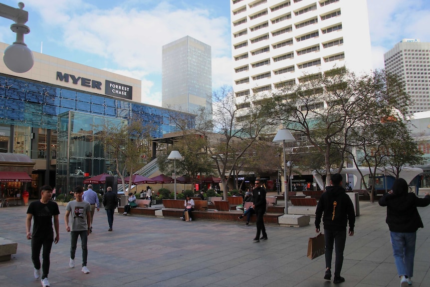 People passing through a plaza in central Perth