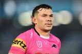 Brent Naden wearing a pink Penrith Panthers jersey looks off screen