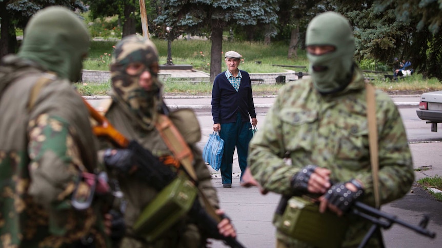 Man looks at Russian separatists in eastern Ukraine