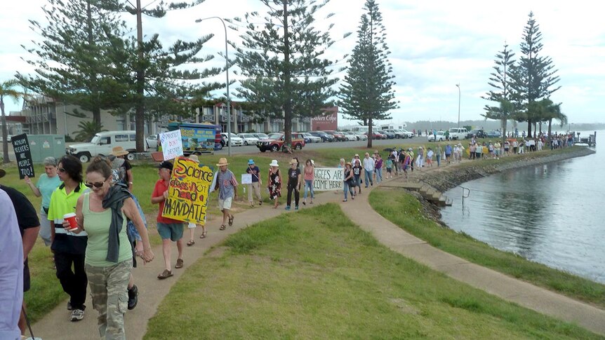 People walk along the shorefront during the March in March protest in Port Macquarie.