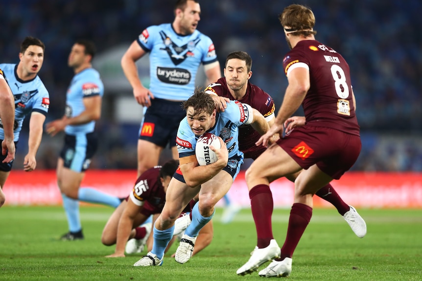 Cameron Murray runs while being tackled by Ben Hunt