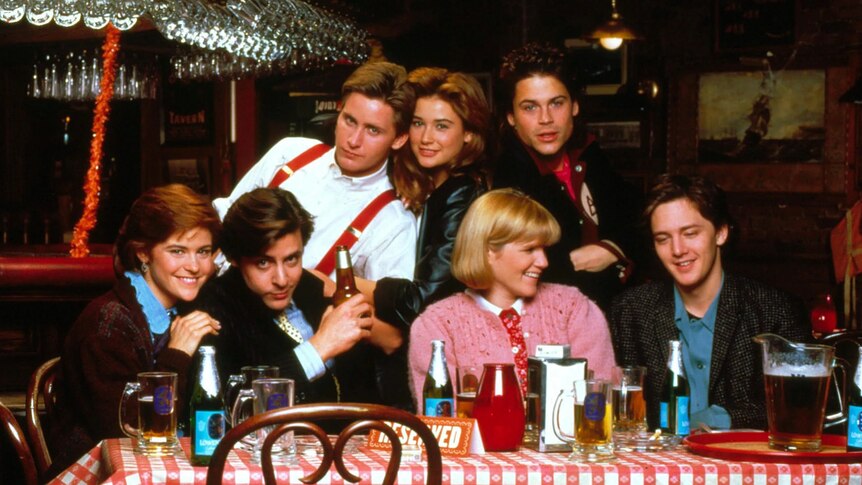 The cast of 1985 movie St Elmo's Fire sitting around a table
