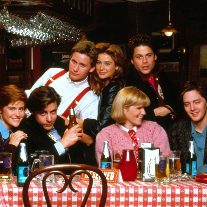 The cast of 1985 movie St Elmo's Fire sitting around a table
