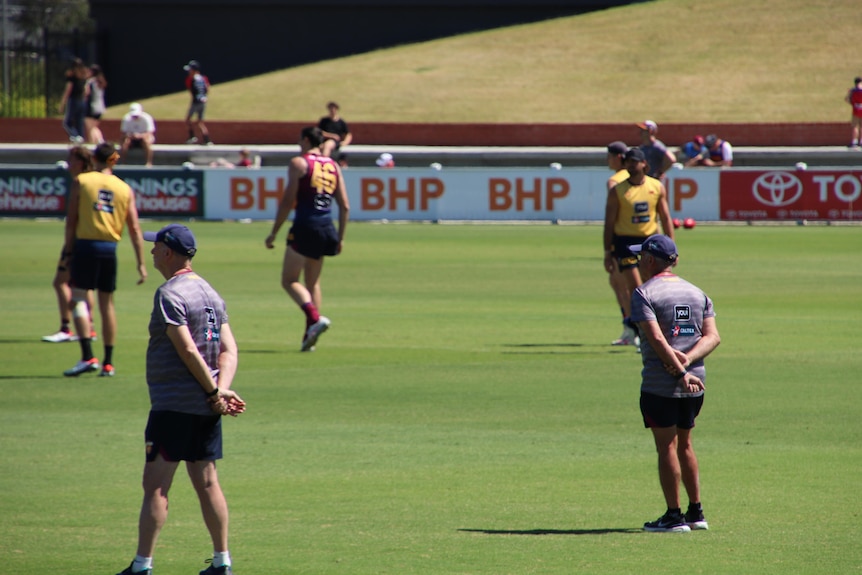 Coaches watch over Brisbane Lions as they train on the field