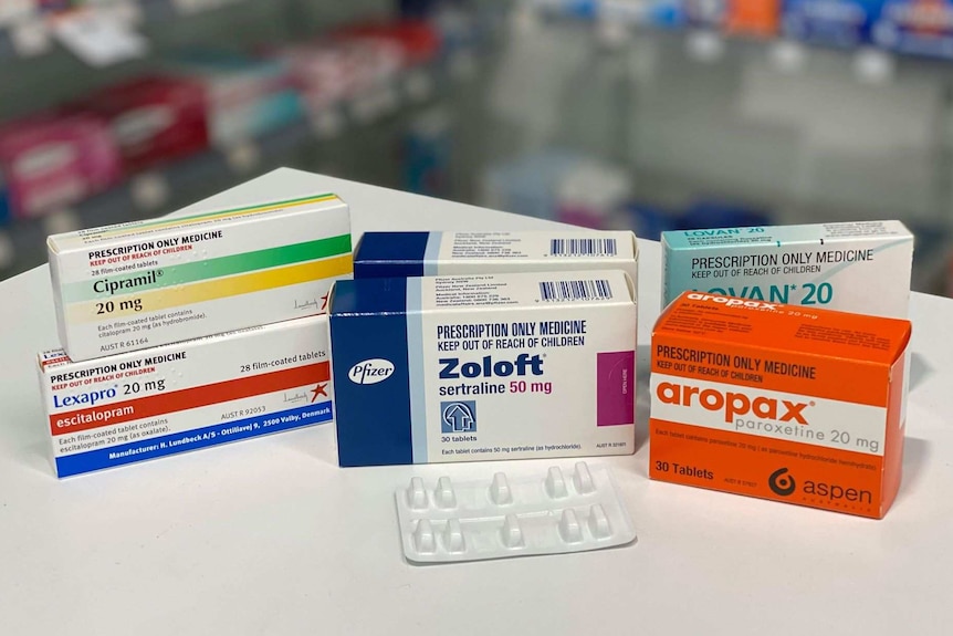 boxes of tablets on a pharmacy bench top