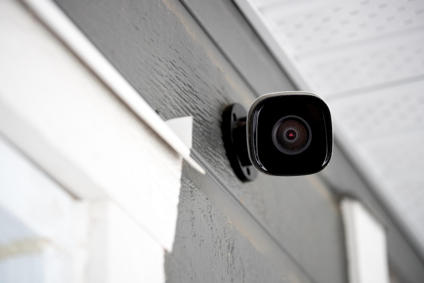A small security camera on a house