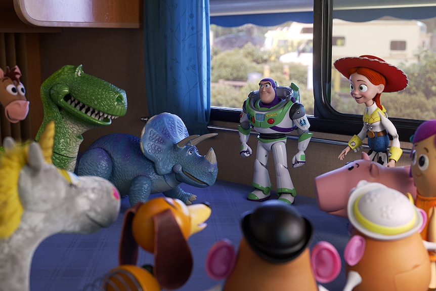 Colour still of various toy characters gathered around Buzz Lightyear and Jessie in RV in 2019 animated film Toy Story 4.