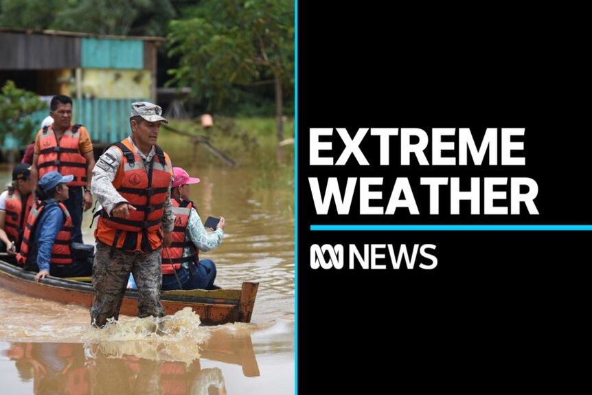 Extreme Weather: Man in military fatigues and life jacket leads boat through floodwaters carrying other people in life jackets.