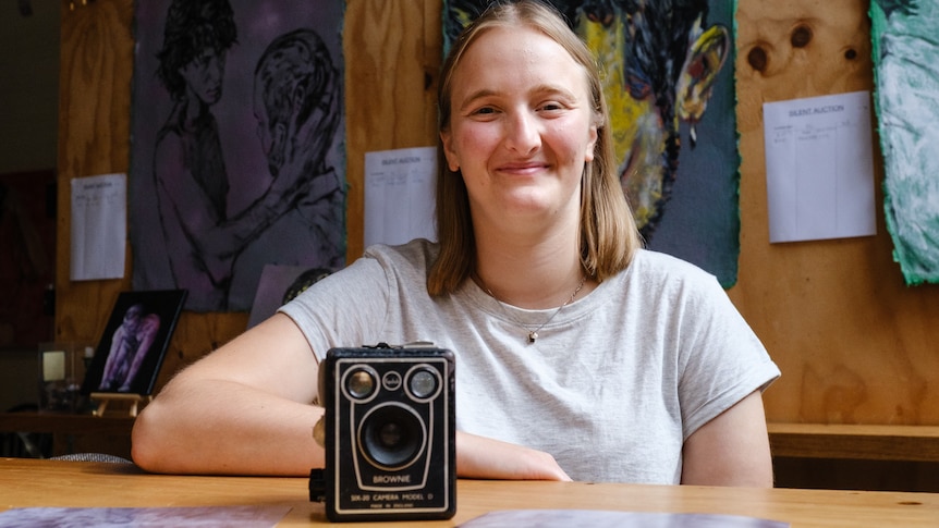 A young woman and an old camera.