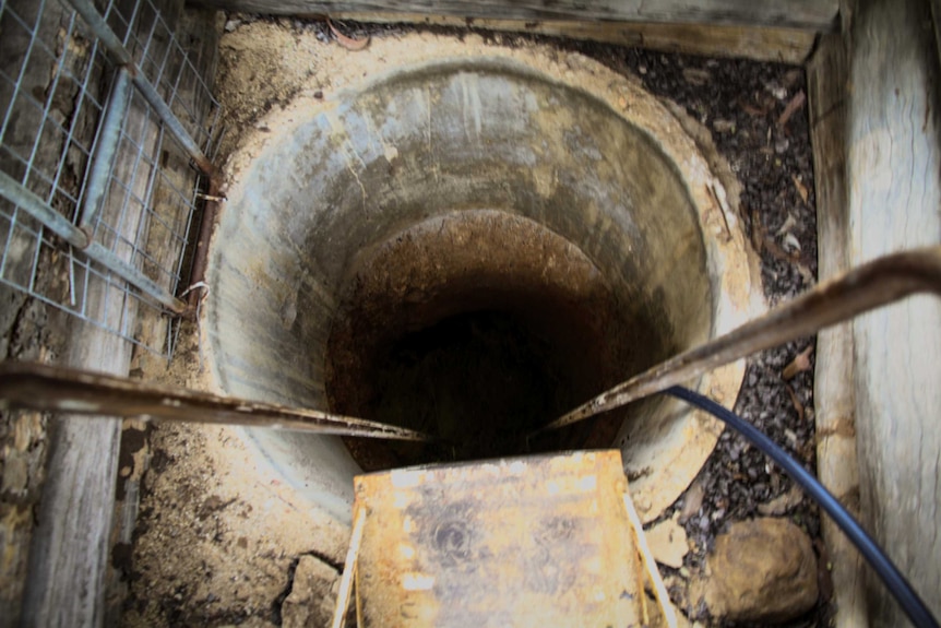 Looking down a shaft leading into a gem mine in Rubyvale