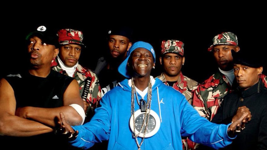 American hip hop group Public Enemy flanked by their S1W security guards