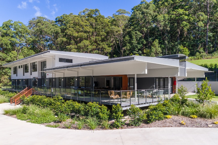 A lowset building amid thick bushland