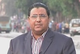 Al Jazeera Arabic producer Mahmoud Hussein stands on a street.