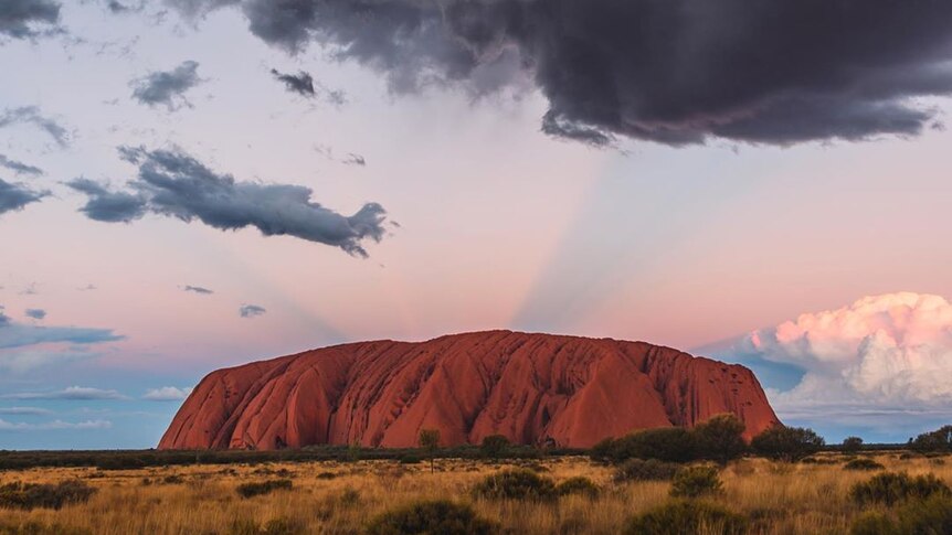 Storm clouds and soft light over Uluru.