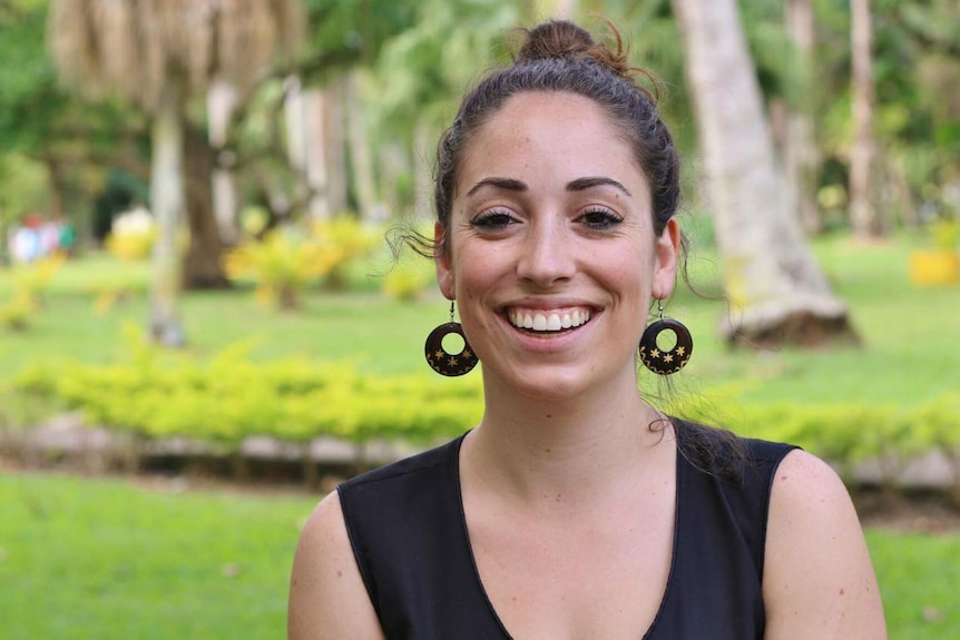 A woman smiles at the camera.