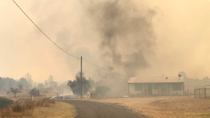 Smoke surrounds Tingha house