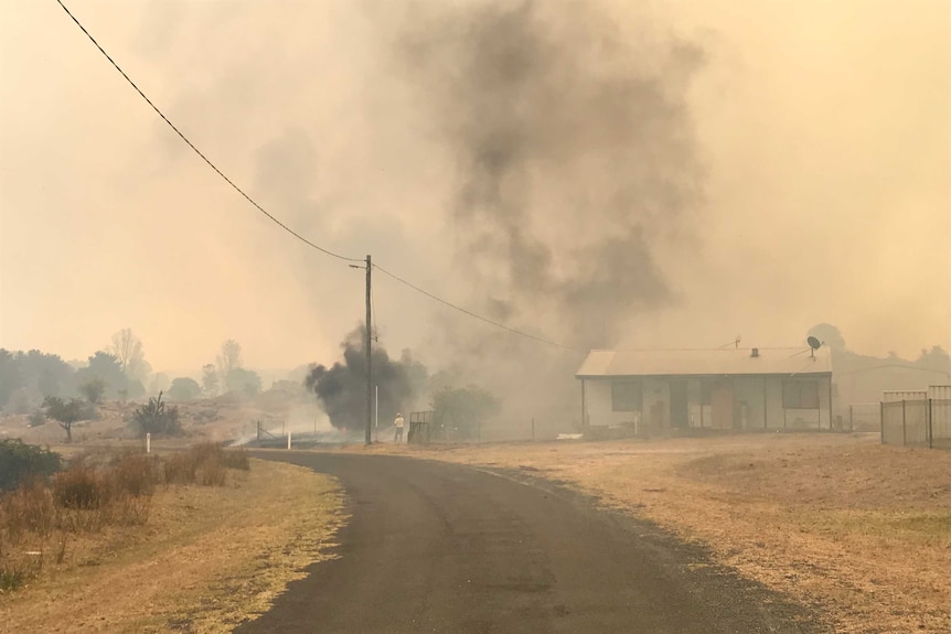 Smoke surrounds Tingha house