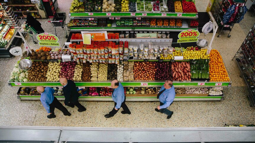 Sam and Mel walk across the supermarket floor followed by their sons Joe Jnr and Joe Snr.