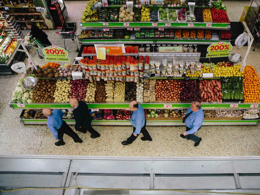 Sam and Mel walk across the supermarket floor followed by their sons Joe Jnr and Joe Snr.