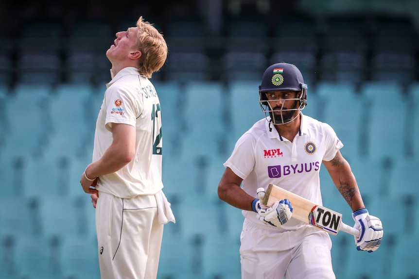 Australia A bowler Will Sutherland looks to the sky as Indian batsman Hanuma Vihari runs between wickets.