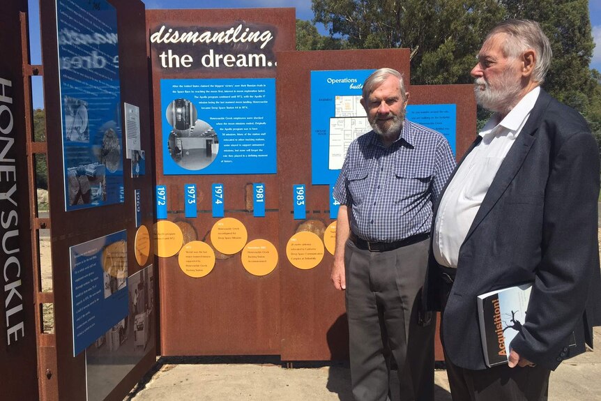 Philip Clark and Hamish Lindsay examine as sign at the site.