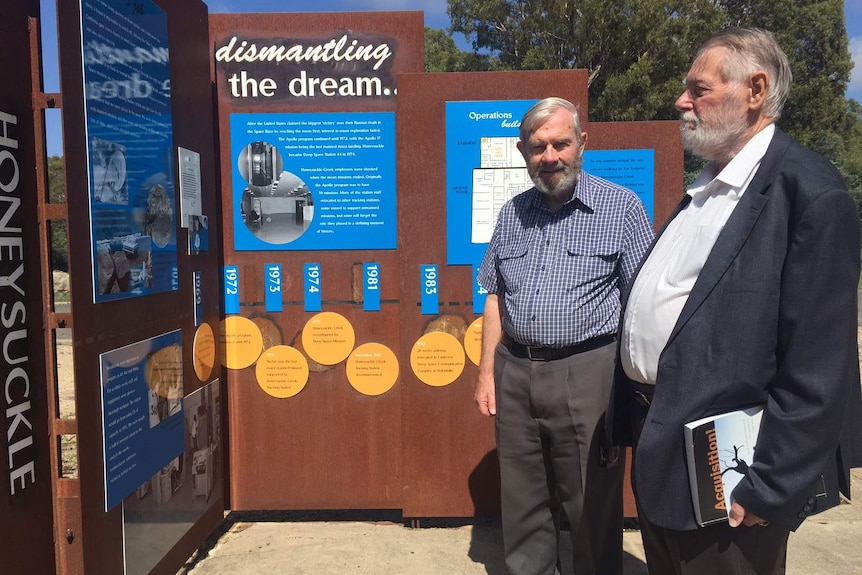 Philip Clark and Hamish Lindsay examine as sign at the site.