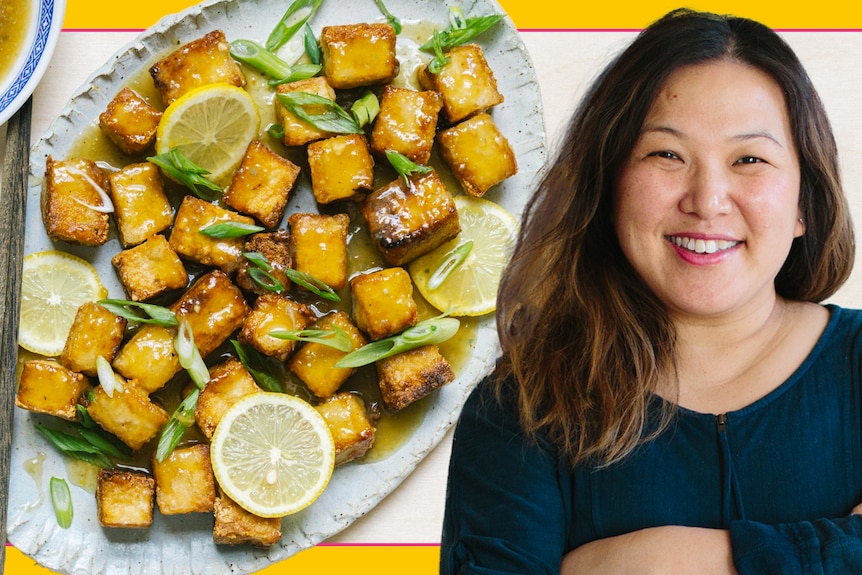 Hetty McKinnon in front of a serving plate of fried tofu covered in a sweet and tangy lemon sauce, a vegetarian recipe.