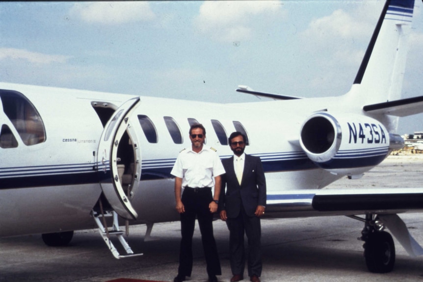 Robert Mazur and a pilot stand in front of a private jet used during an undercover cartel operation.