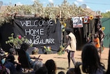 A photo of a traditional Indigenous ceremony in front of a shrine for Balang E Lewis.
