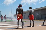 Inidgenous dancers in traditional body paint perform a smoking ceremony to open the new Darwin prison