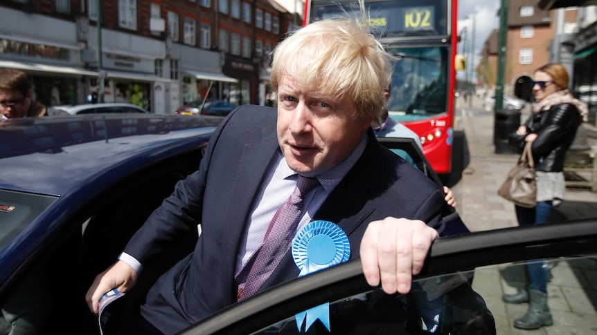 Boris Johnson leaves Golders Green by car, he is climbing into the car.