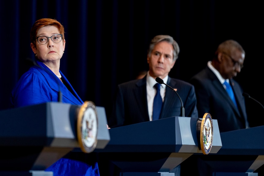 Australian Foreign Minister Mary Spean stands on the podium and looks into the distance