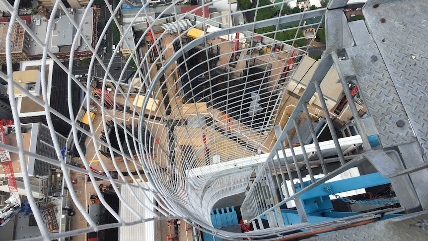 A photo of a worksite from inside a crane stairwell.