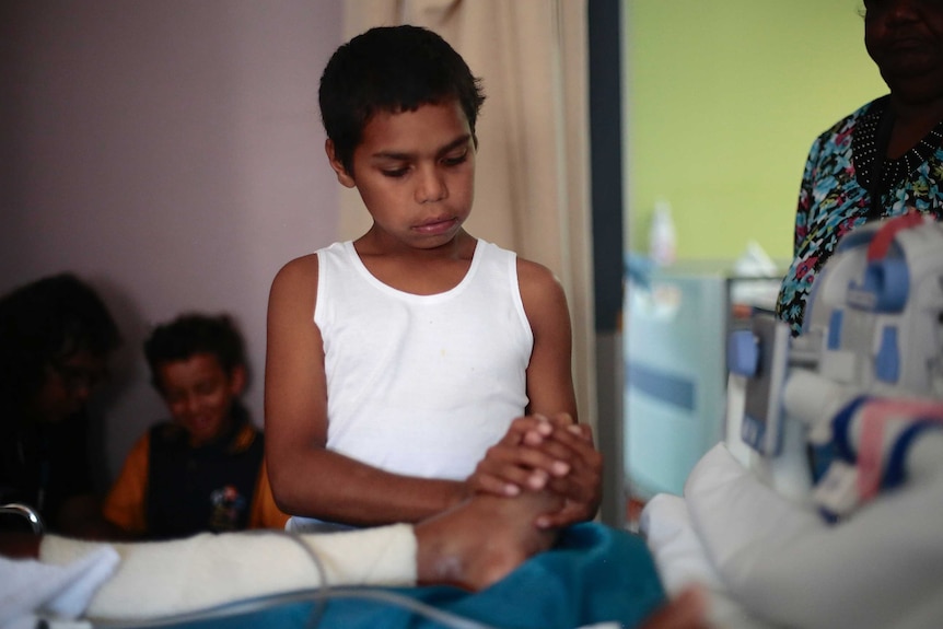 An Aboriginal child (Dujuan Hoosan) healing a foot in the documentary In My Blood It Runs