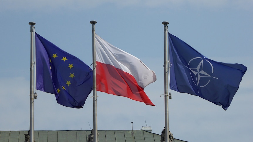 The flags of the EU, Poland and NATO