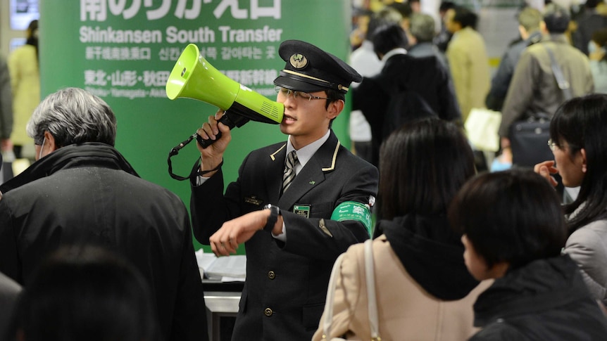 Japanese train attendant addresses passengers