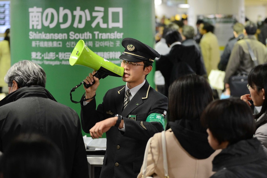 Japanese train attendant addresses passengers